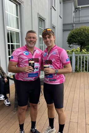 Damian and Adam in matching pink cycling kit after a charity cycle